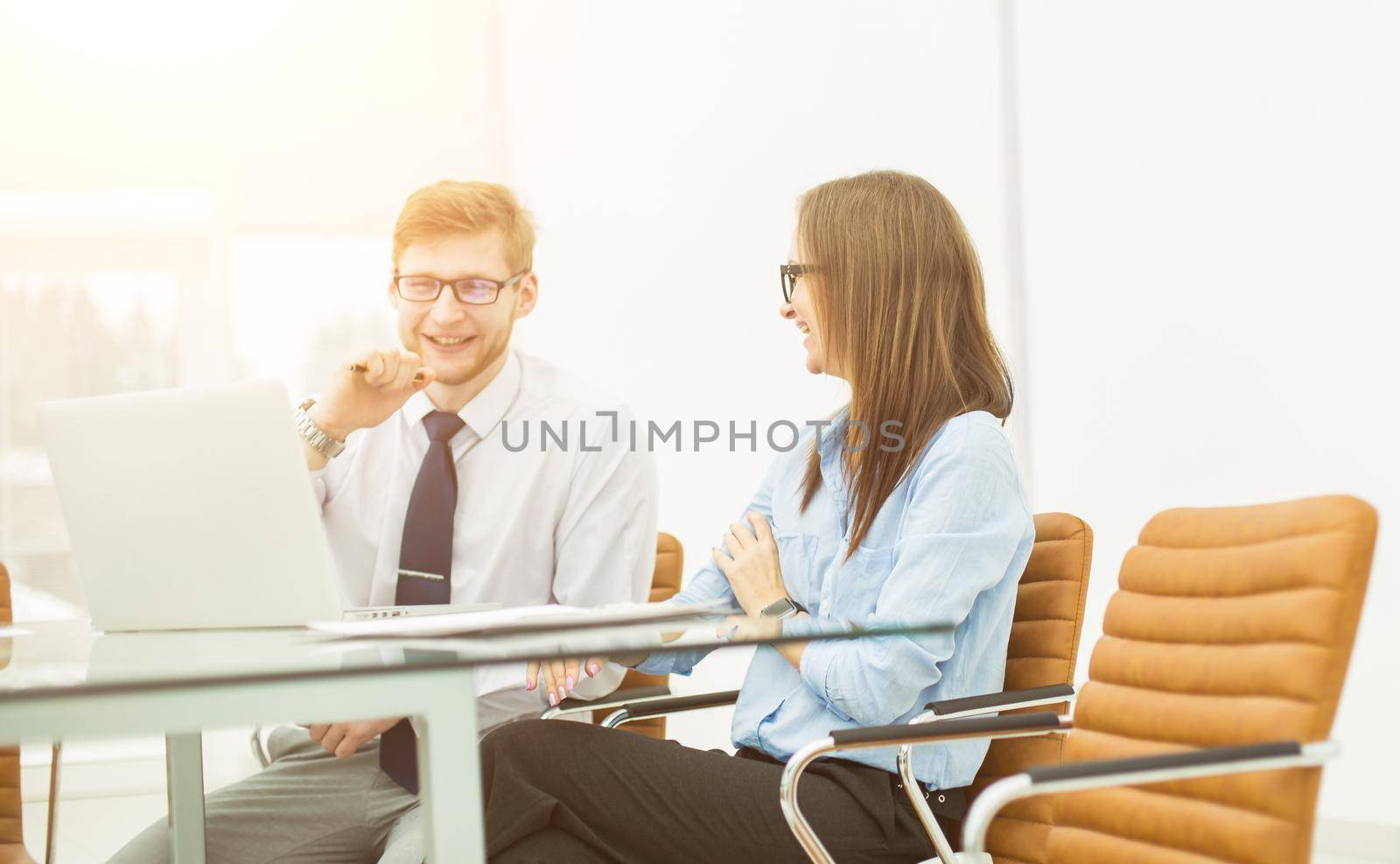 experienced staff of the company discuss the current problems at the Desk in the conference room.the photo has a empty space for your text