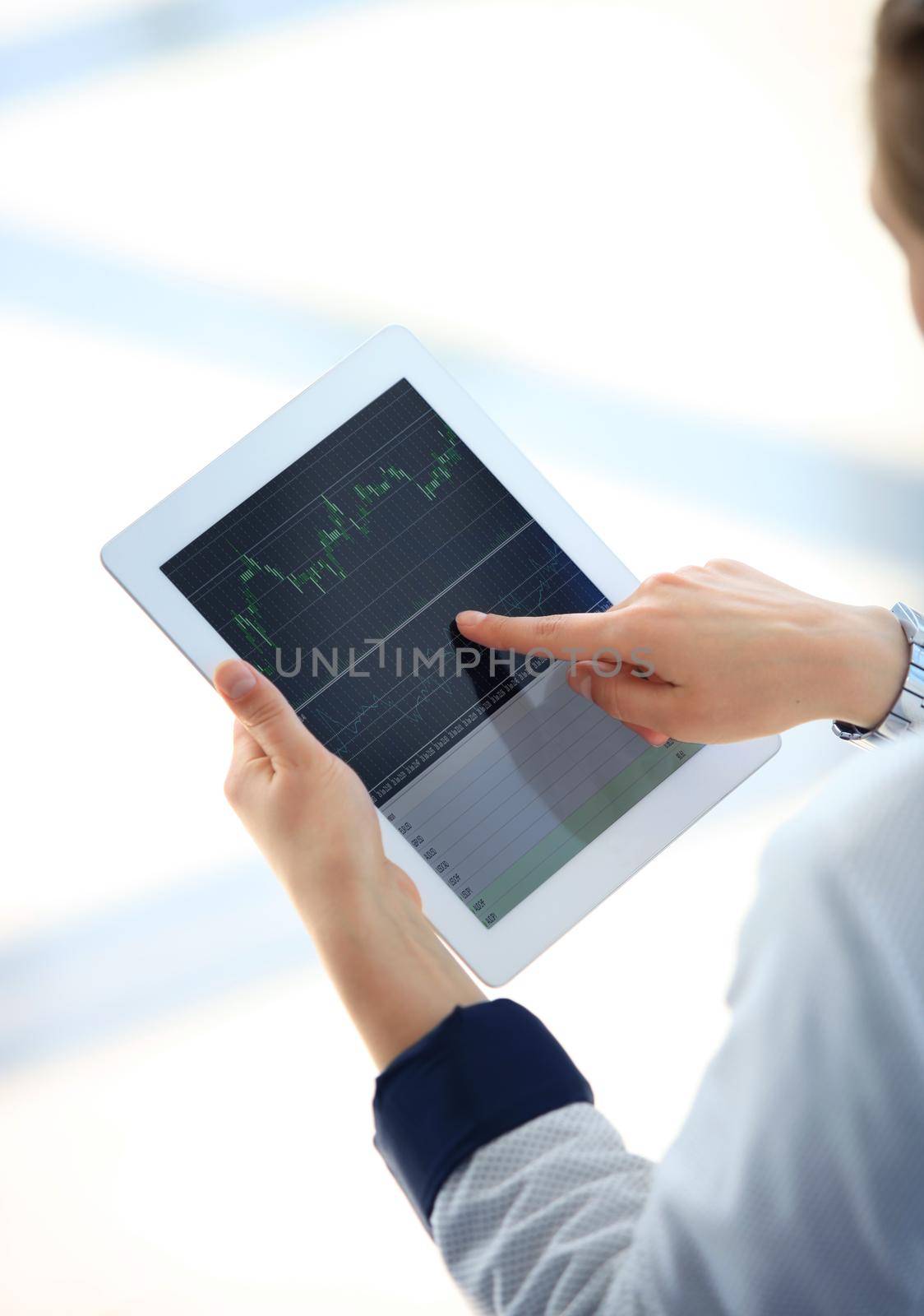 Close-up image of an office worker using a touchpad to analyze statistical data by tsyhun