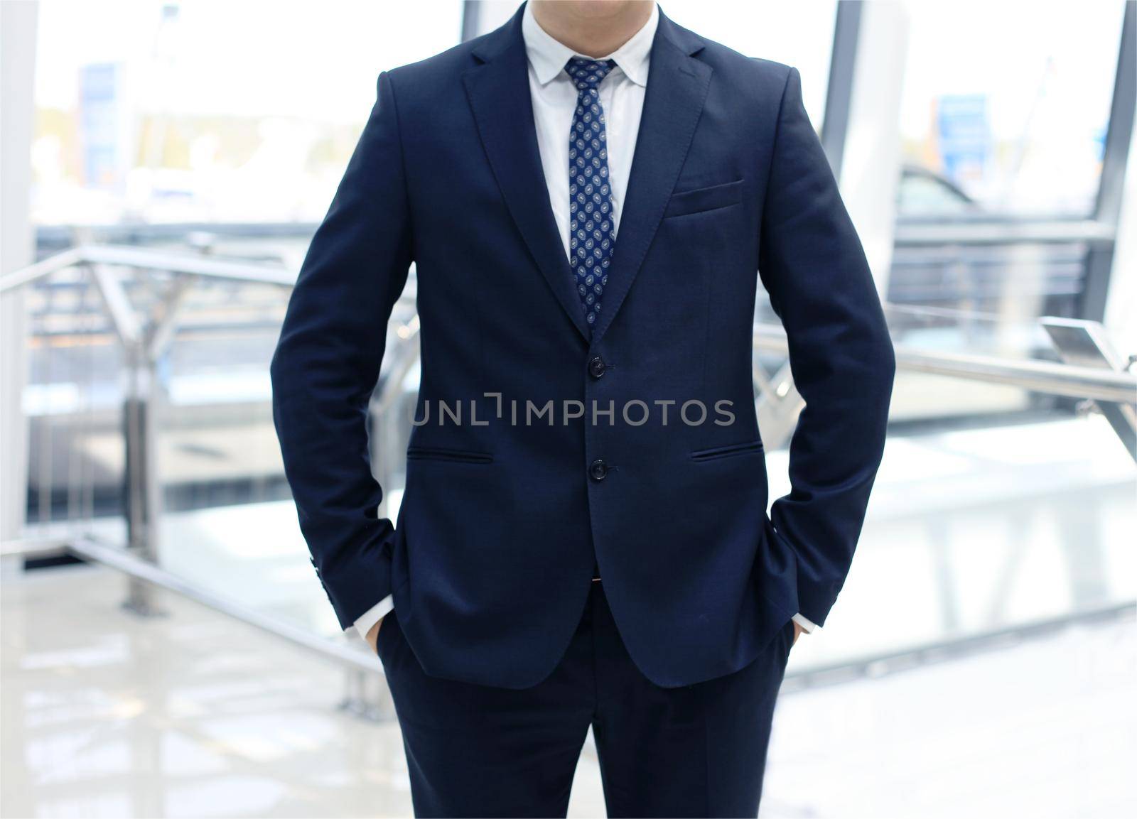 businessman standing with his hands in the pockets