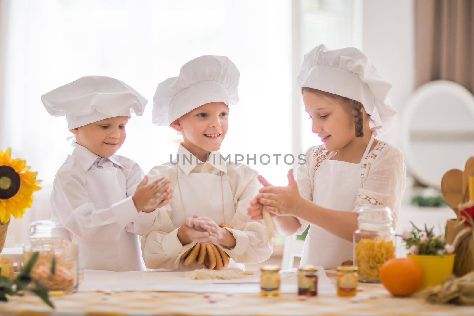 happy little children in the form of a chef to cook a delicious breakfast the kitchen