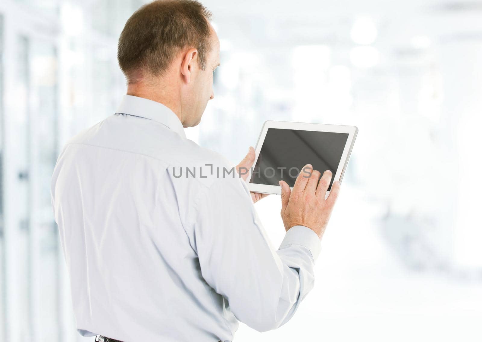 closeup of a businessman holding a tablet. the photo has a empty space for your text