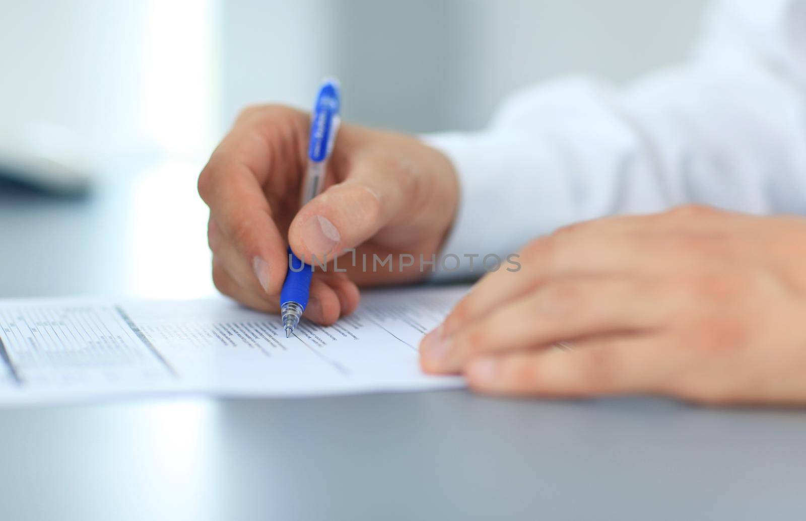 Hands writing on a paper