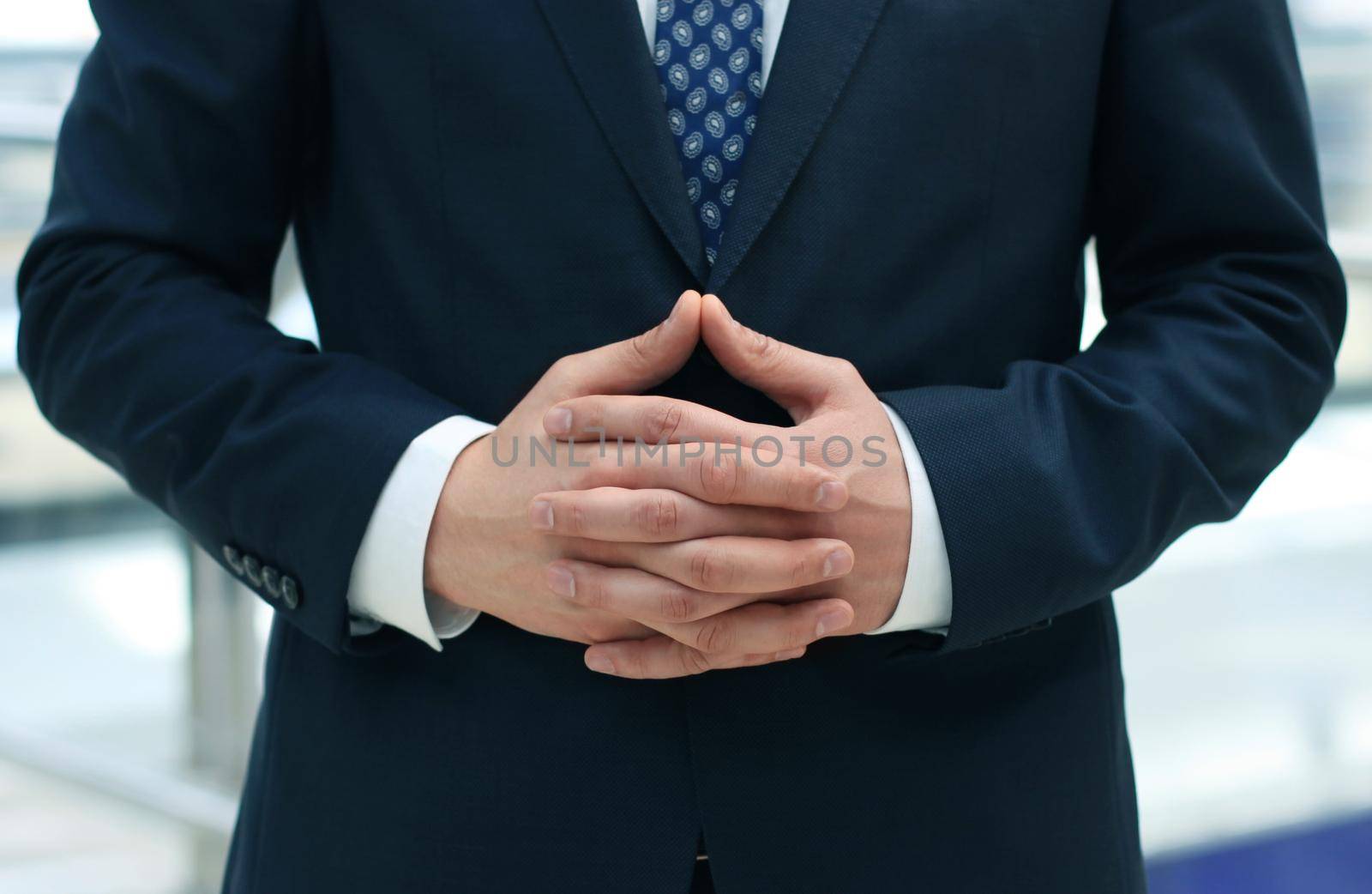 Businessman waiting with folded hands