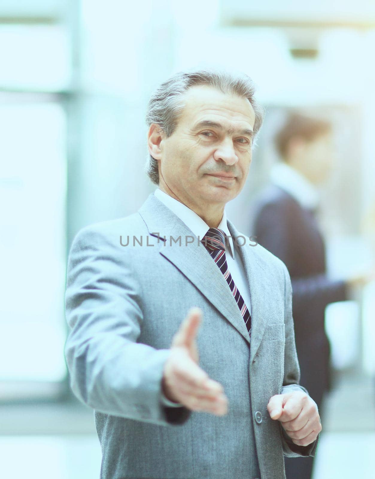 Welcoming business man ready to handshake with hand extended