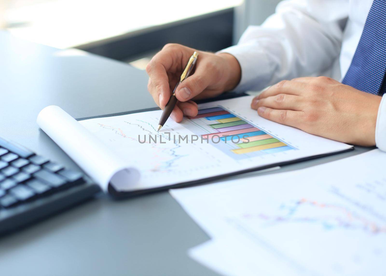 Close-up of graphs and charts analyzed by businessman by tsyhun