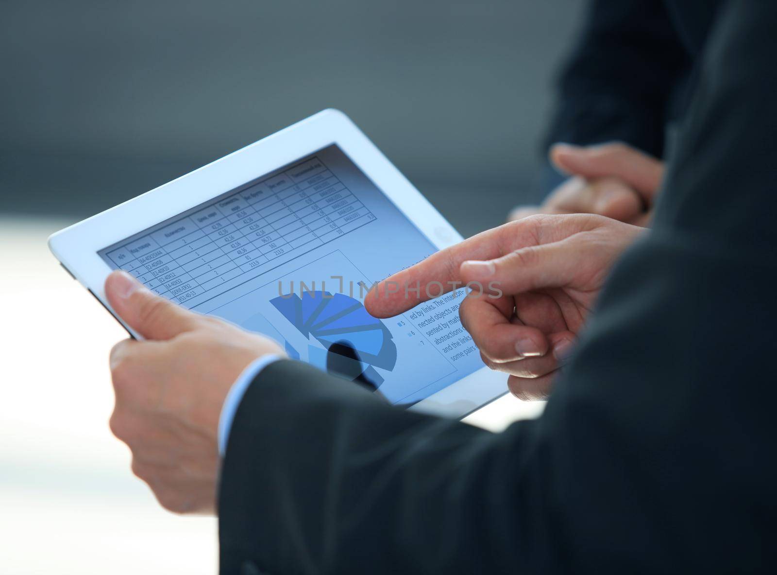 businessman holding digital tablet in office by tsyhun