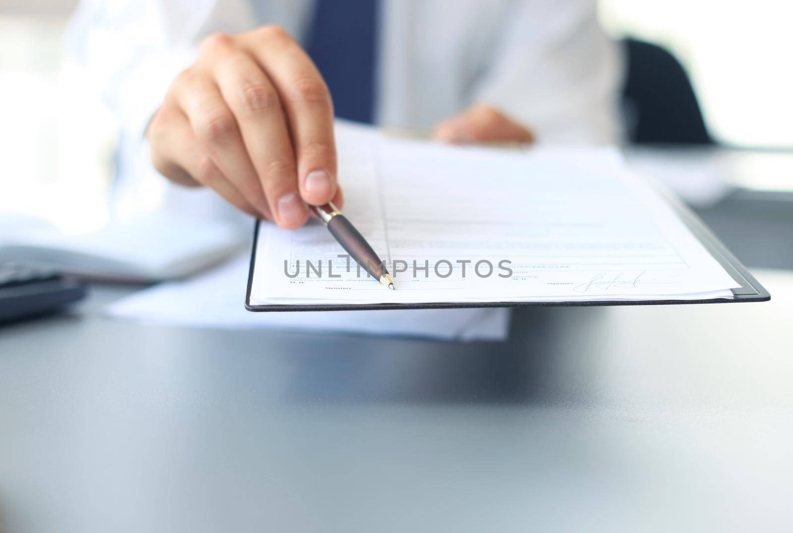 Image of business document being shown by female by tsyhun