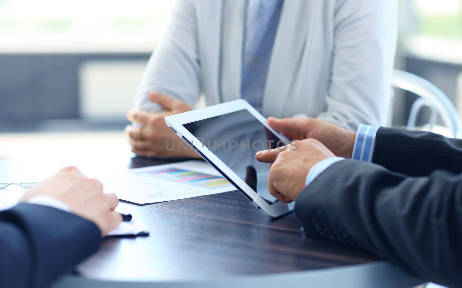 businessman holding digital tablet in office by tsyhun