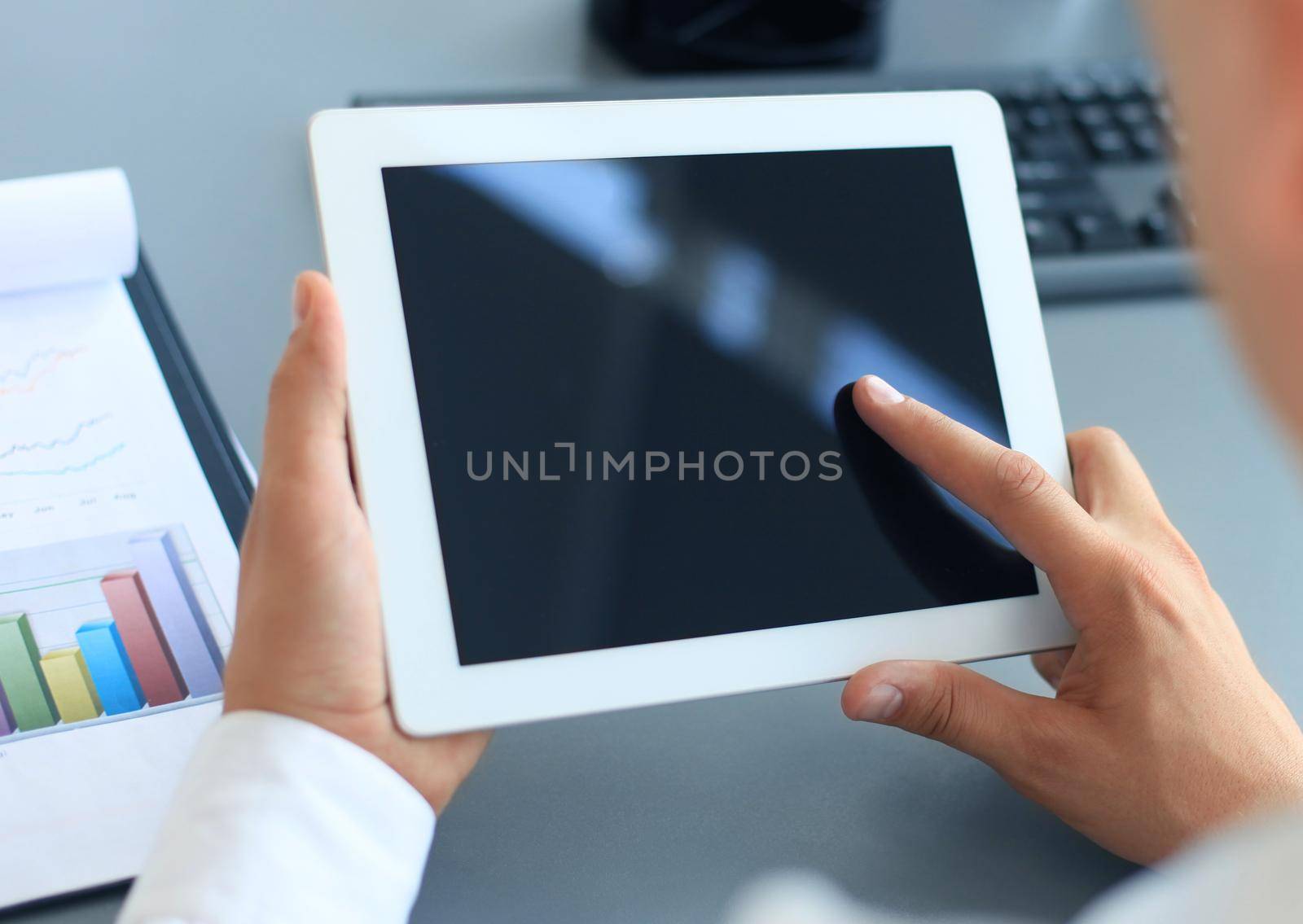 Businessman holding digital tablet by tsyhun