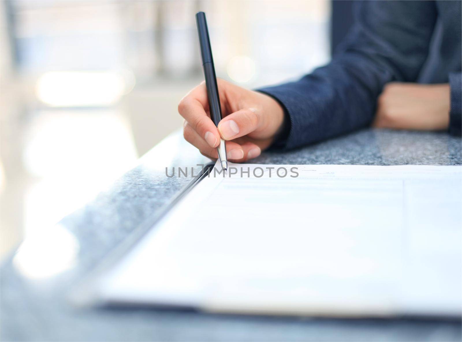 Close-up of Businesswoman makes a note at business document