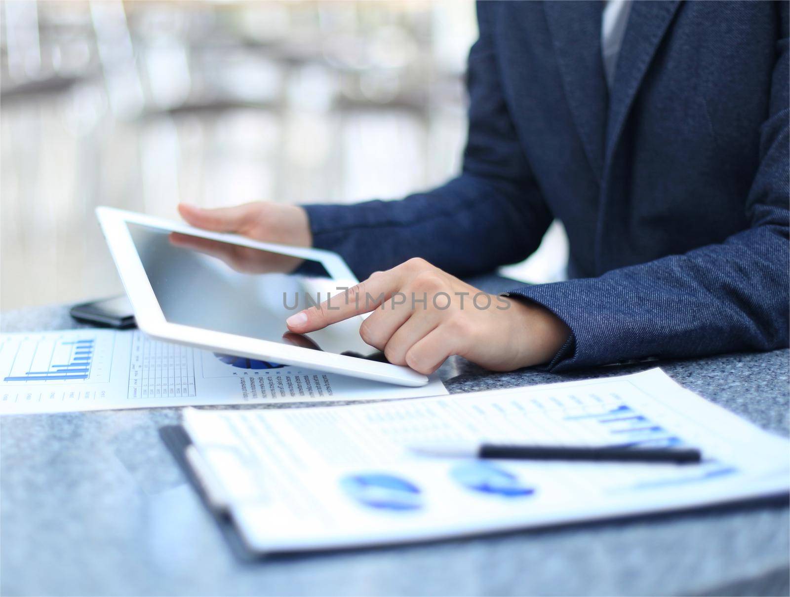 Businessman using digital tablet computer with modern mobile phone