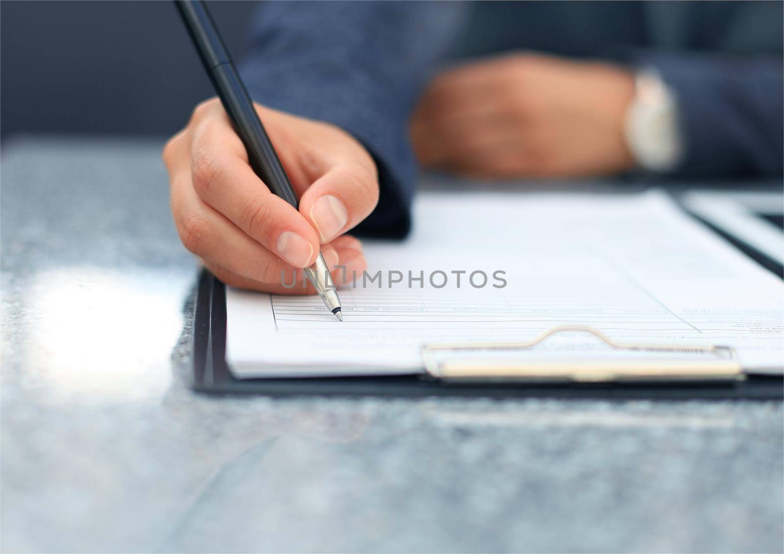 Close-up of Businesswoman makes a note at business document