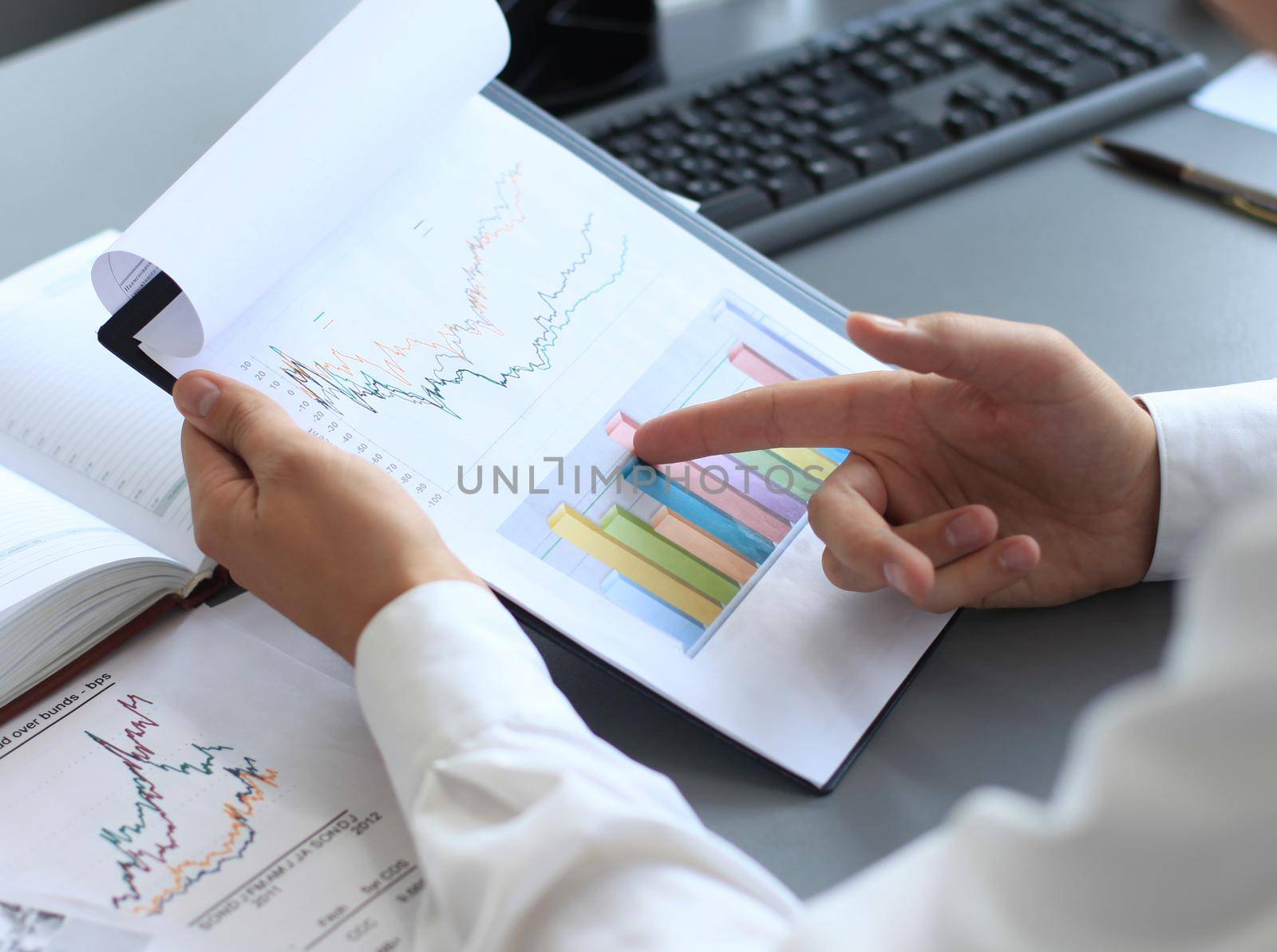 Close-up of graphs and charts analyzed by businessman by tsyhun