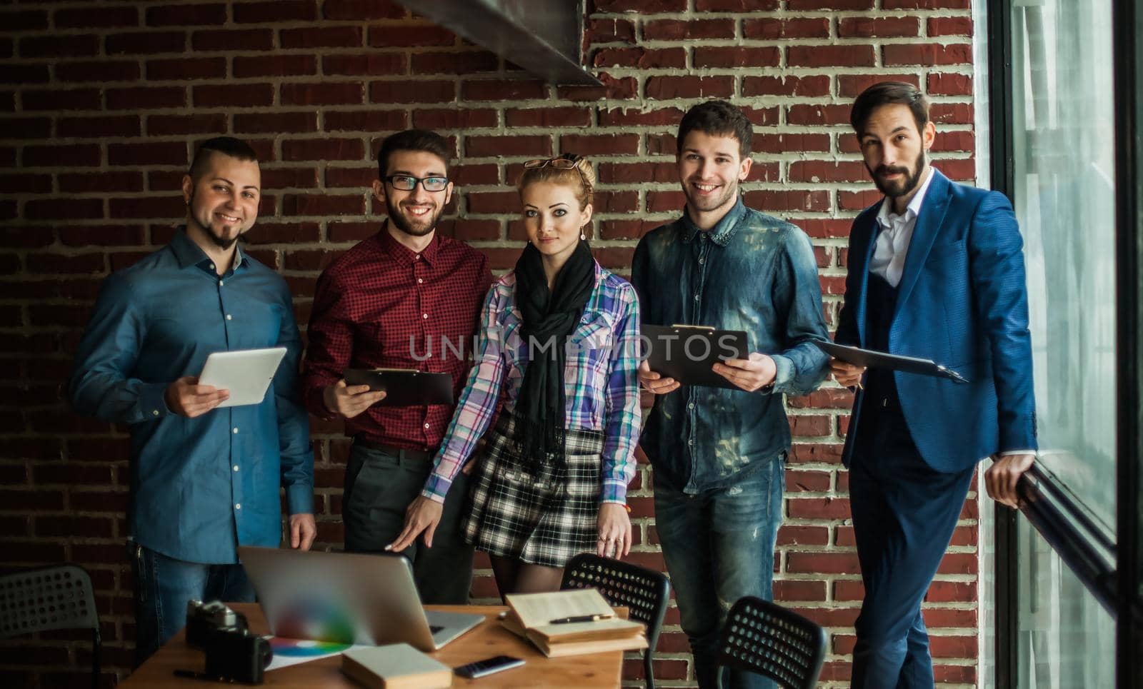 business team with documents being prepared to discuss the advertising project in modern office