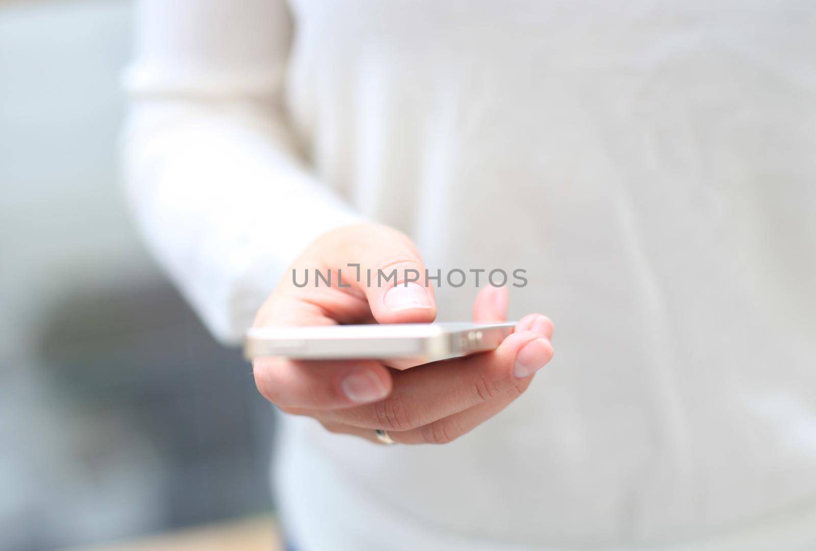 Close up of a woman using mobile smart phone by tsyhun