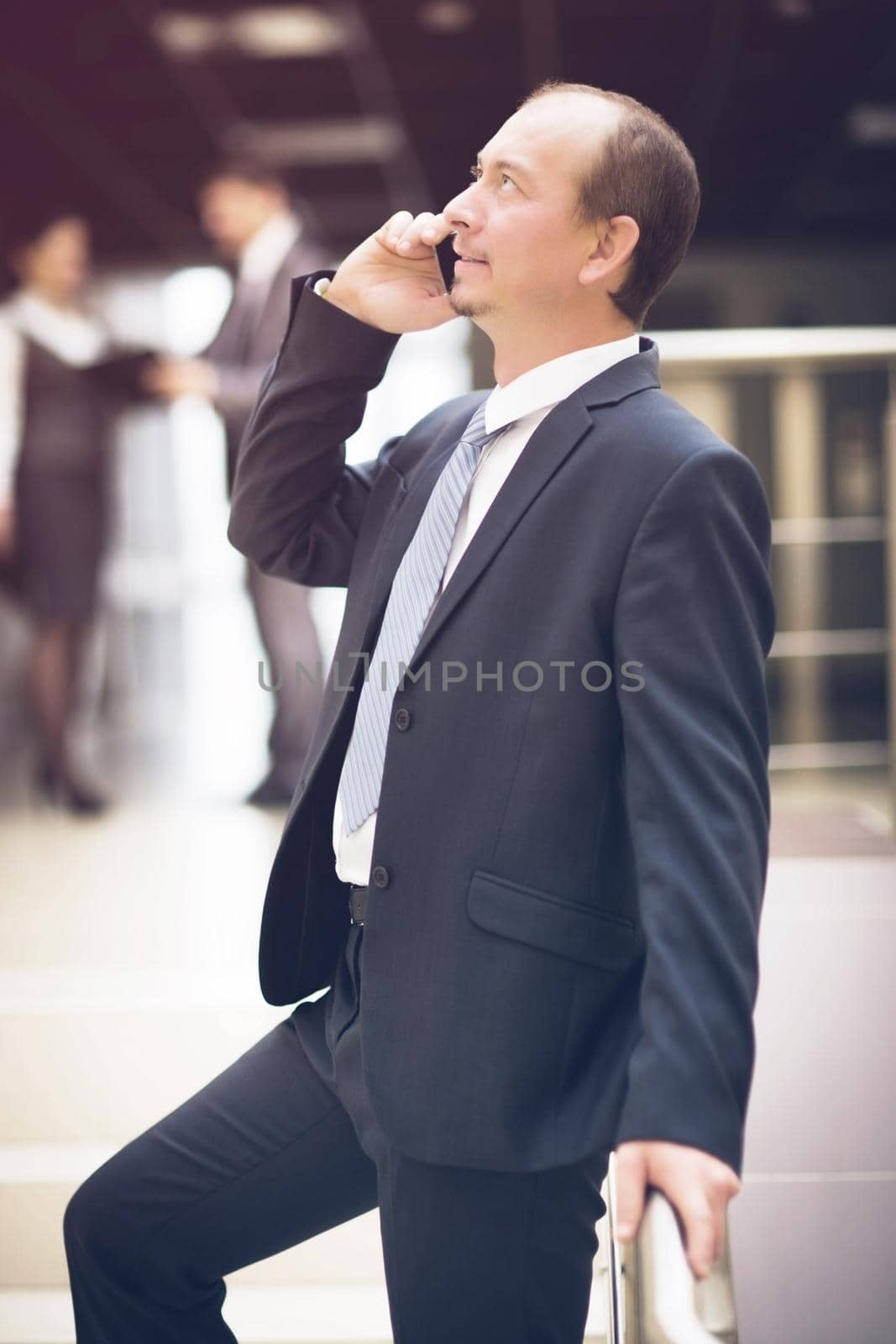 business man talking on cell phone at modern office