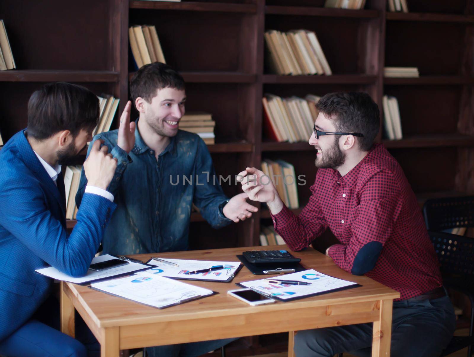 successful business team is working with the financial schedules in the workplace in modern office