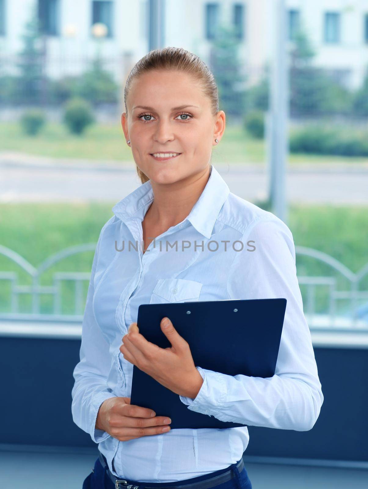 Closeup portrait of cute young business woman smiling by tsyhun