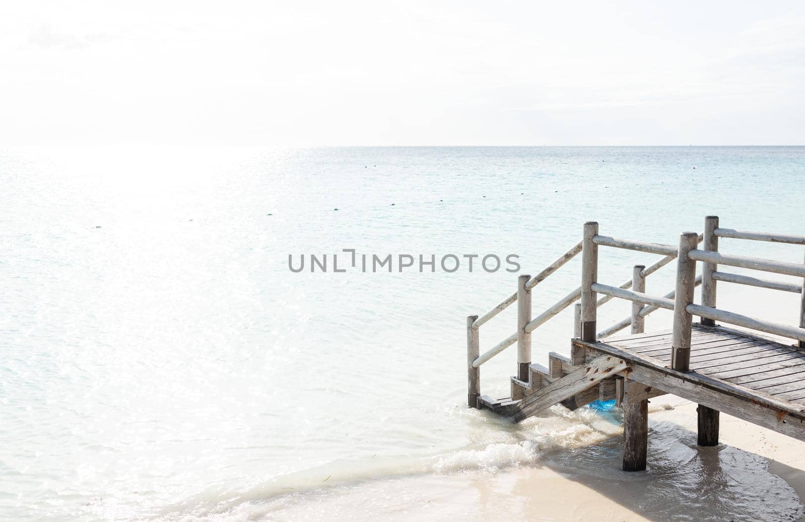 Beautiful tropical steps into turquoise sea water