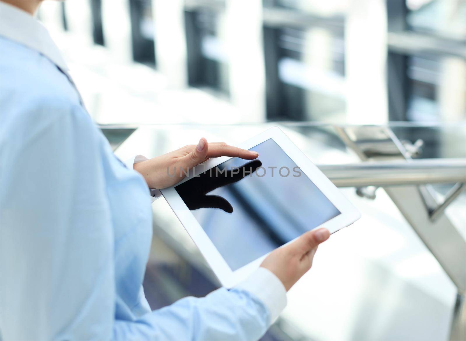 Business woman working with a digital tablet at modern office by tsyhun