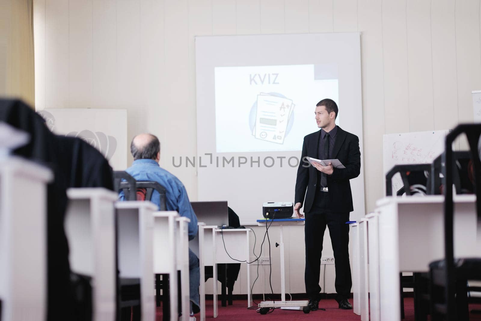 young business man giving presentation and education leassons on seminar event in small bright conference room