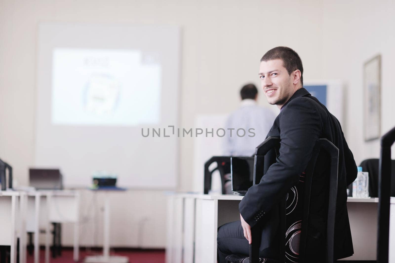 young business man giving presentation and education leassons on seminar event in small bright conference room