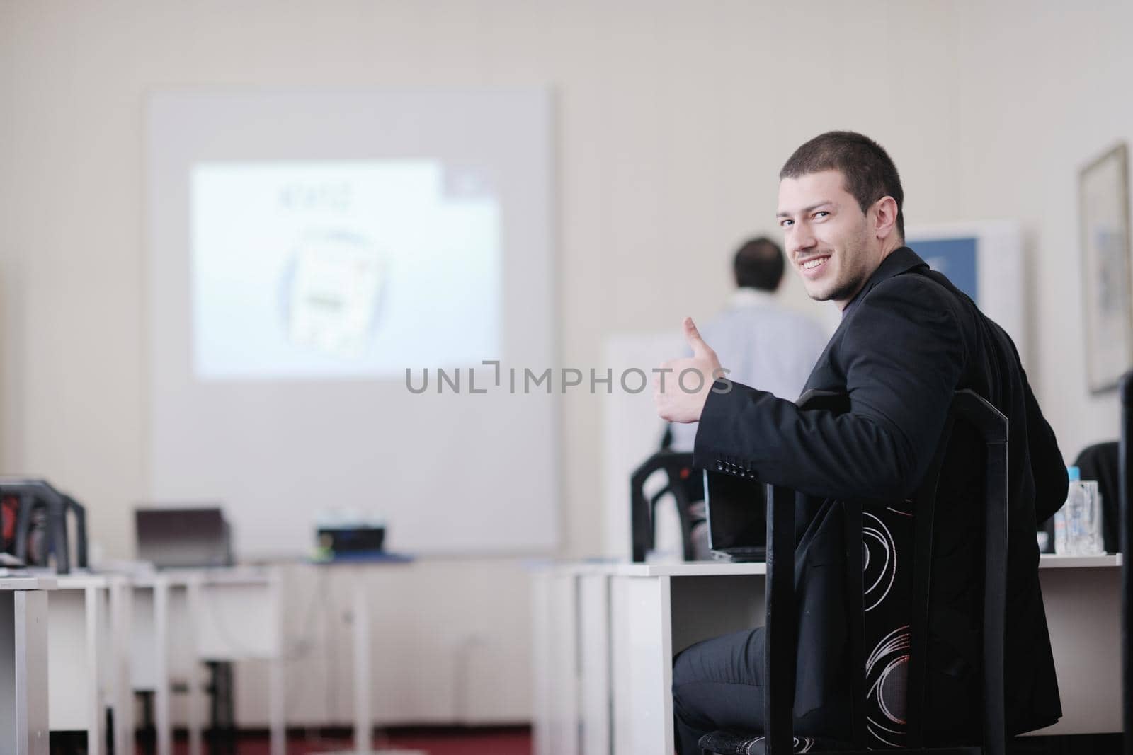 young business man giving presentation and education leassons on seminar event in small bright conference room