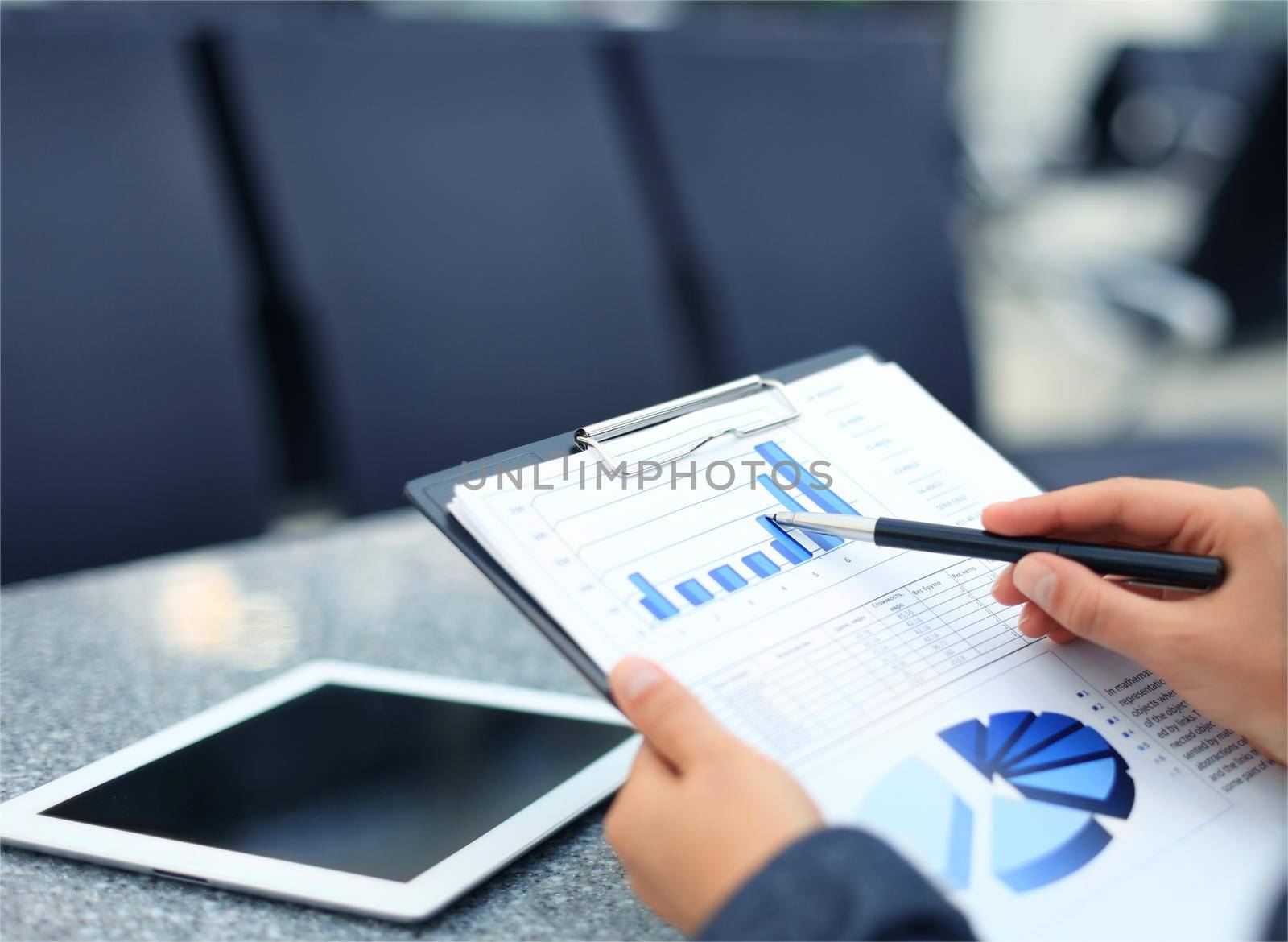 Close-up of graphs and charts analyzed by businesswoman