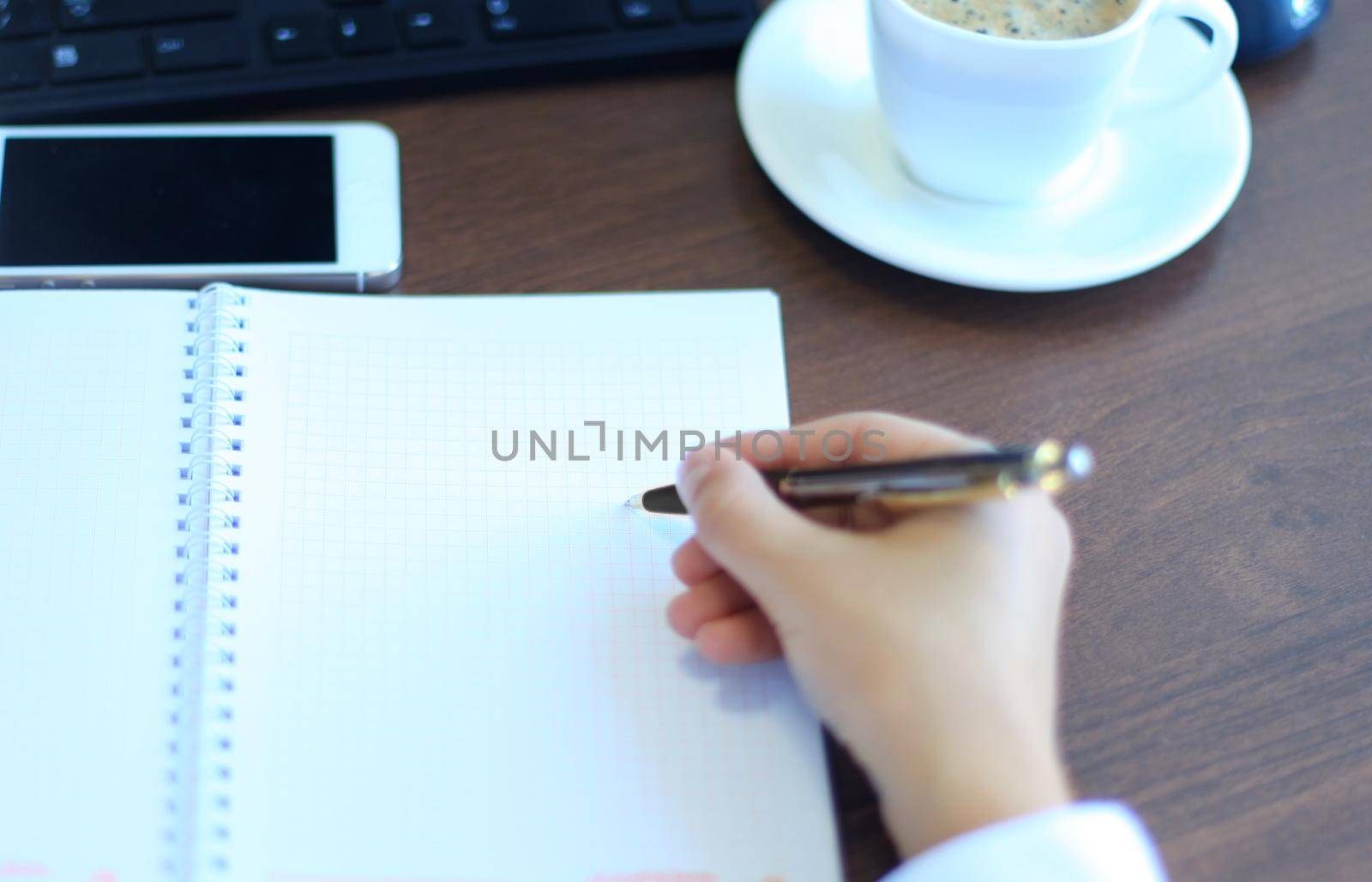 Close-up of Businesswoman makes a note at business document