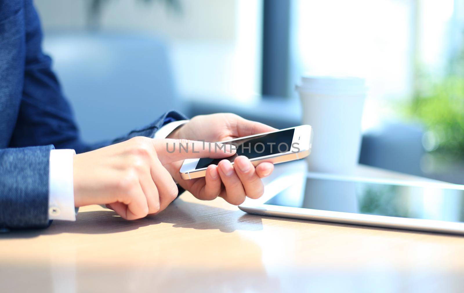 Young businesswoman working with modern devices, digital tablet computer and mobile phone by tsyhun