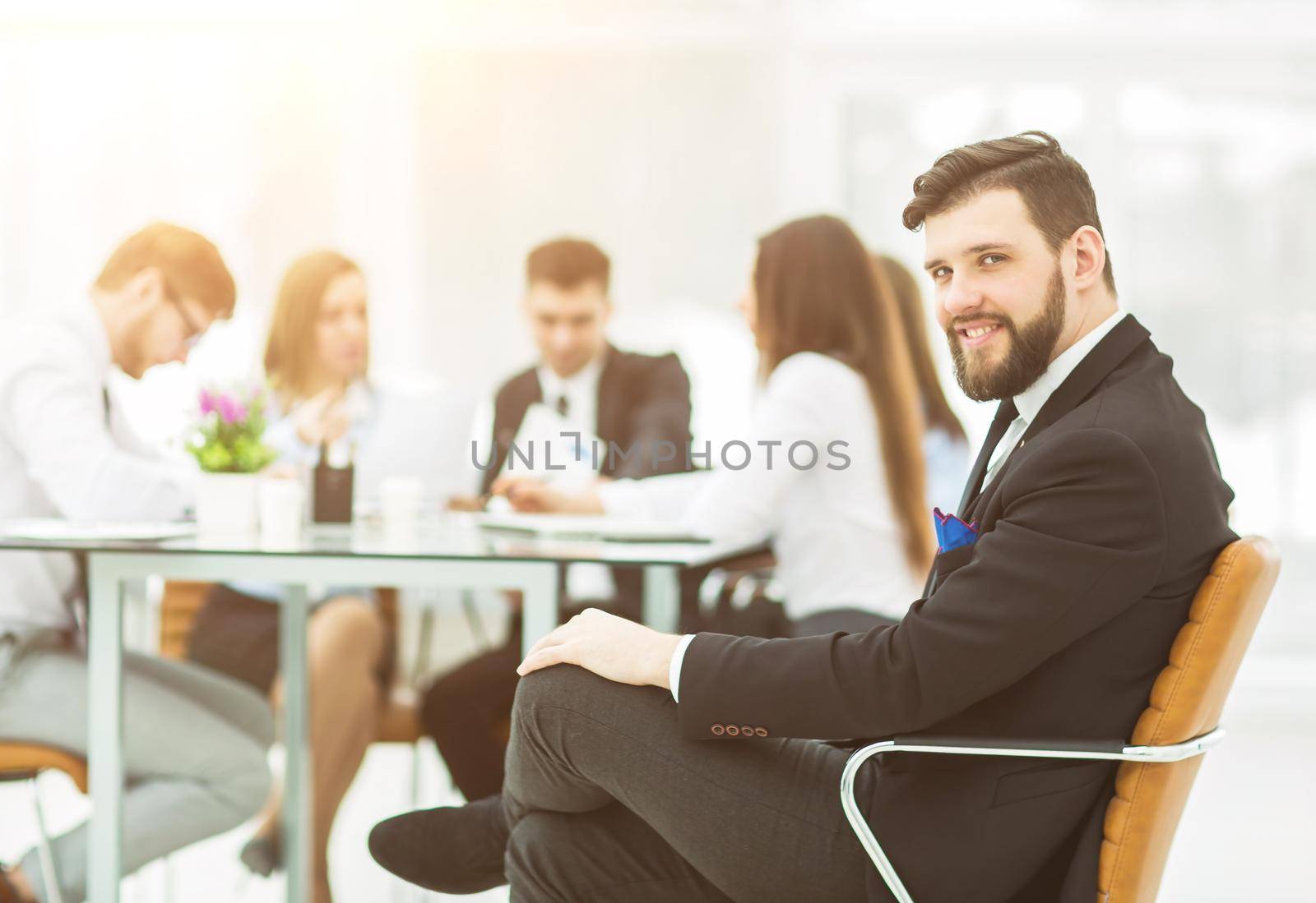 financial Manager of the company on the background of the working meeting the business team.the photo has a empty space for your text