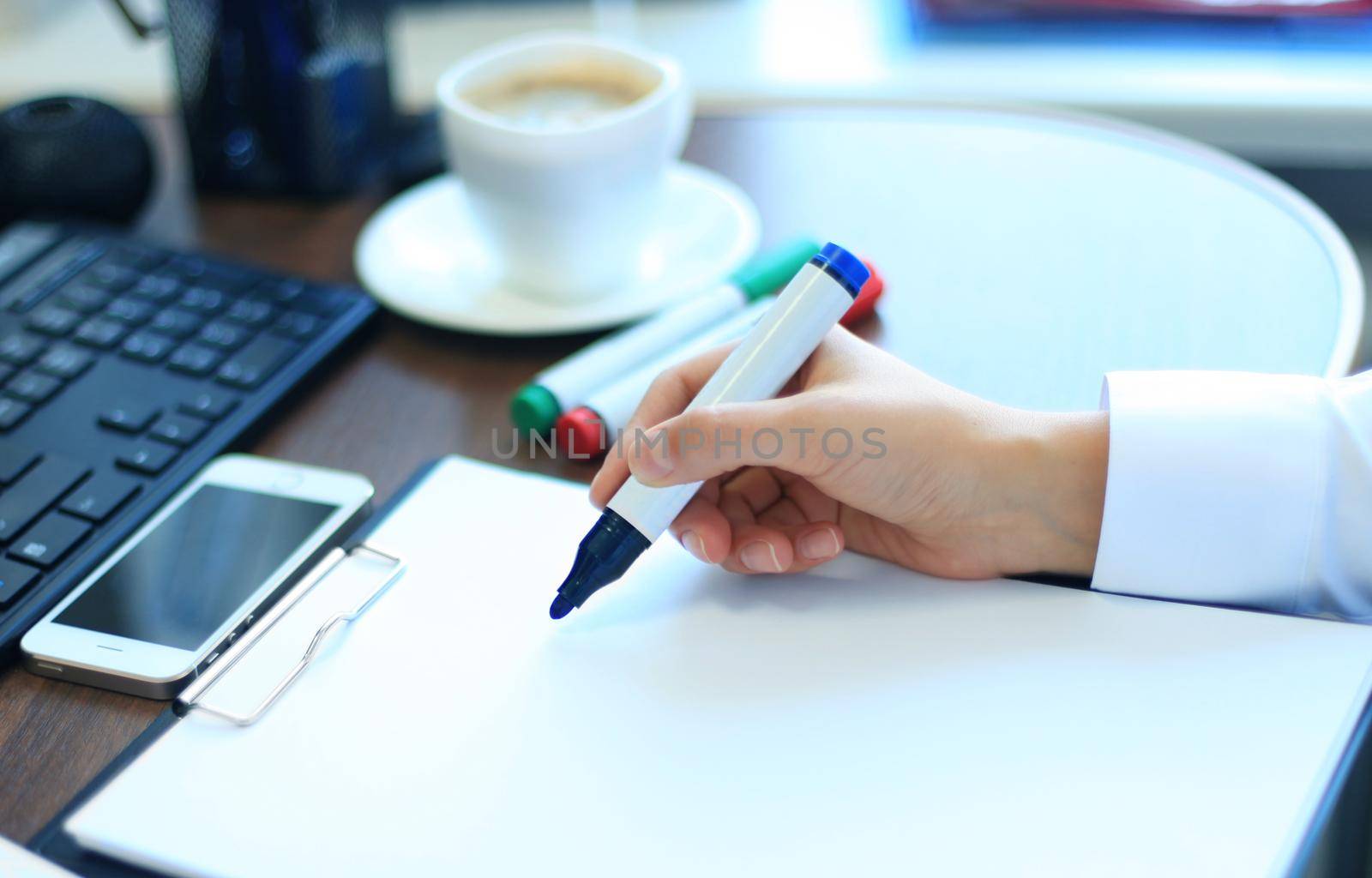 Close-up of Businesswoman makes a note at business document