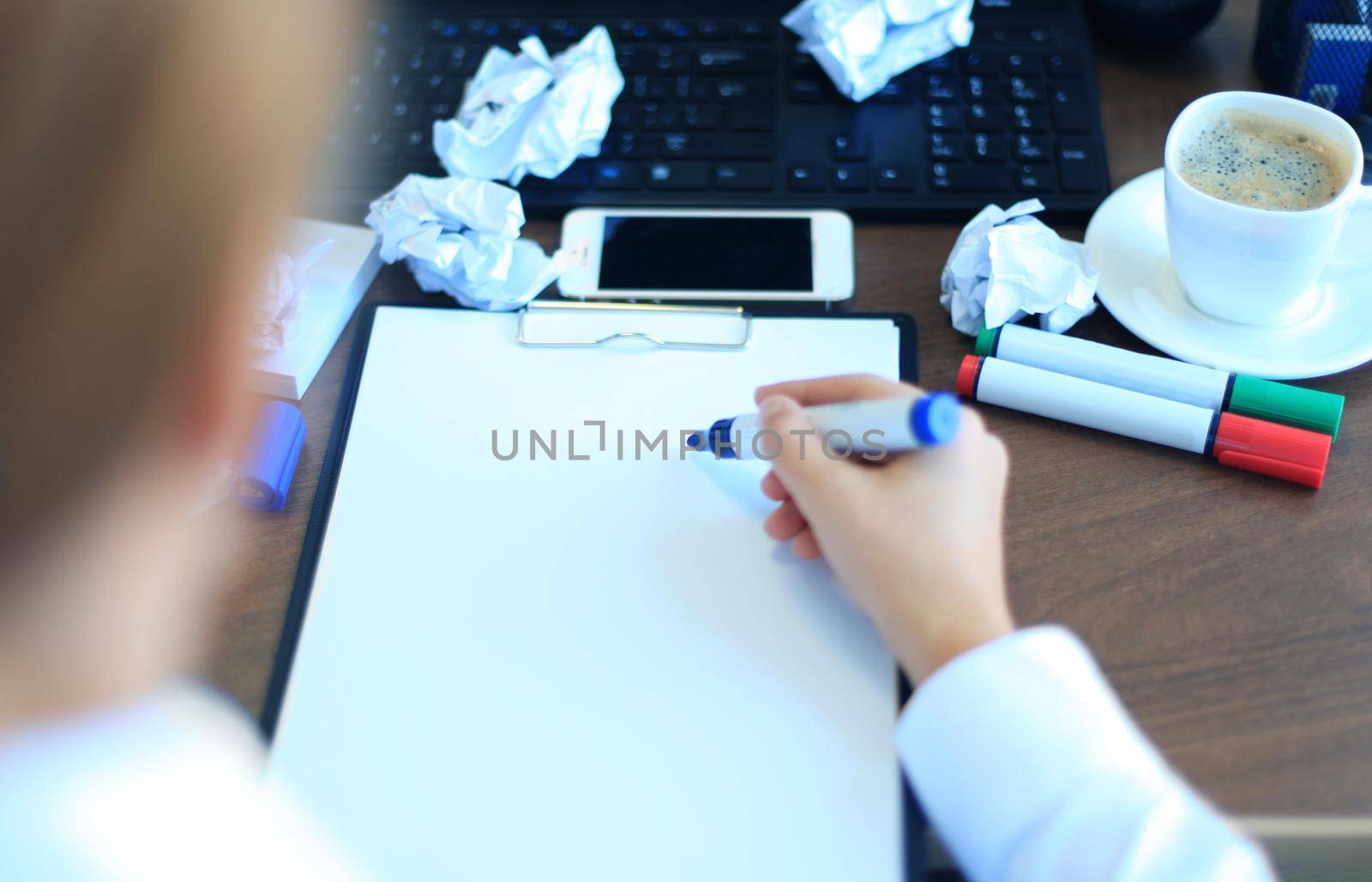 Close-up of Businesswoman makes a note at business document