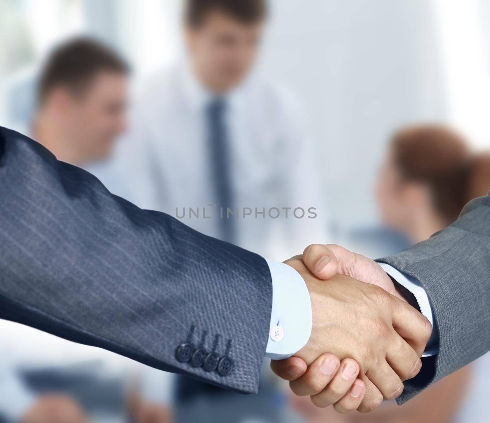 Closeup of a business hand shake between two colleagues by tsyhun