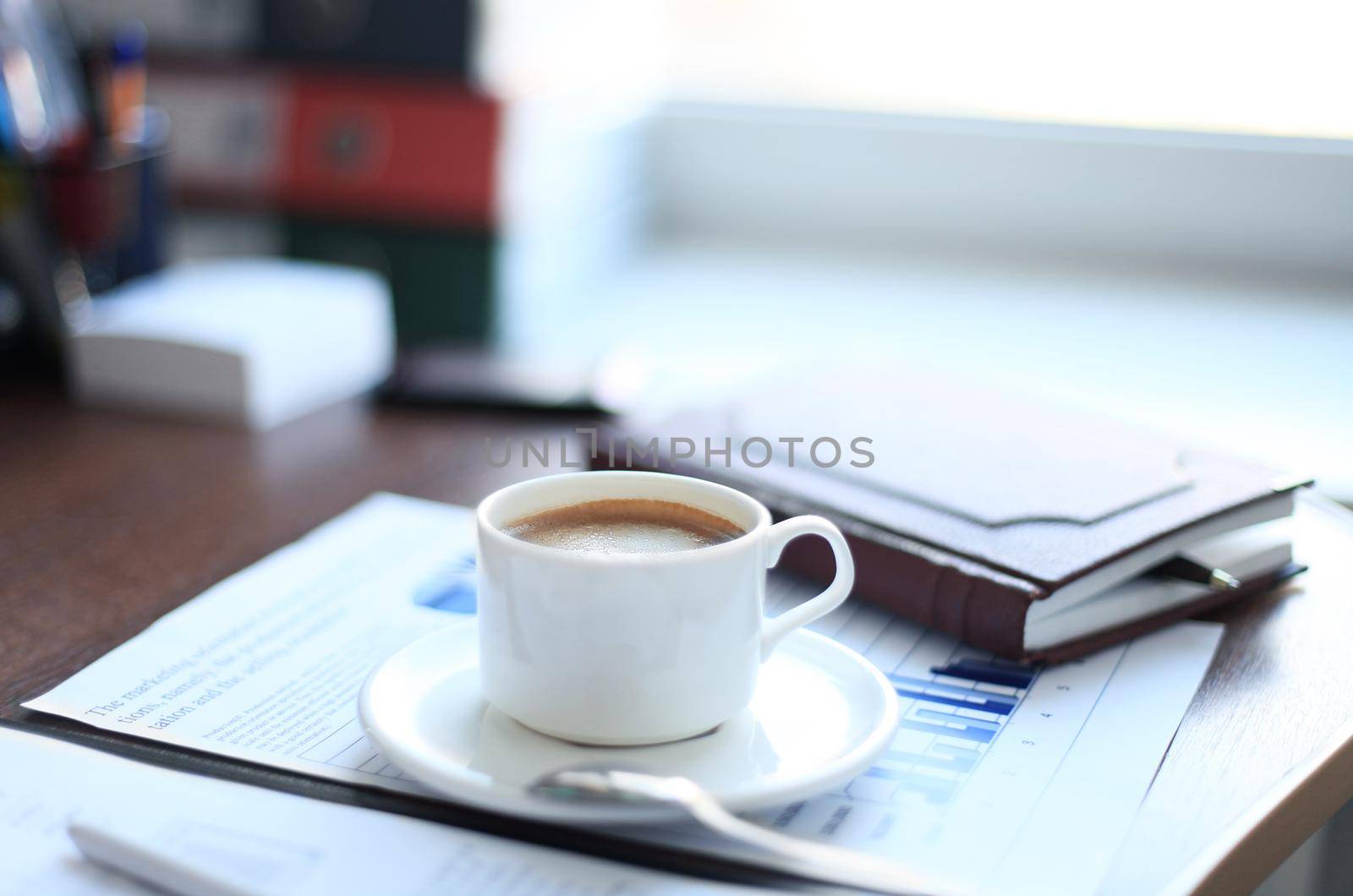 Office supplies and coffee cup on table by tsyhun