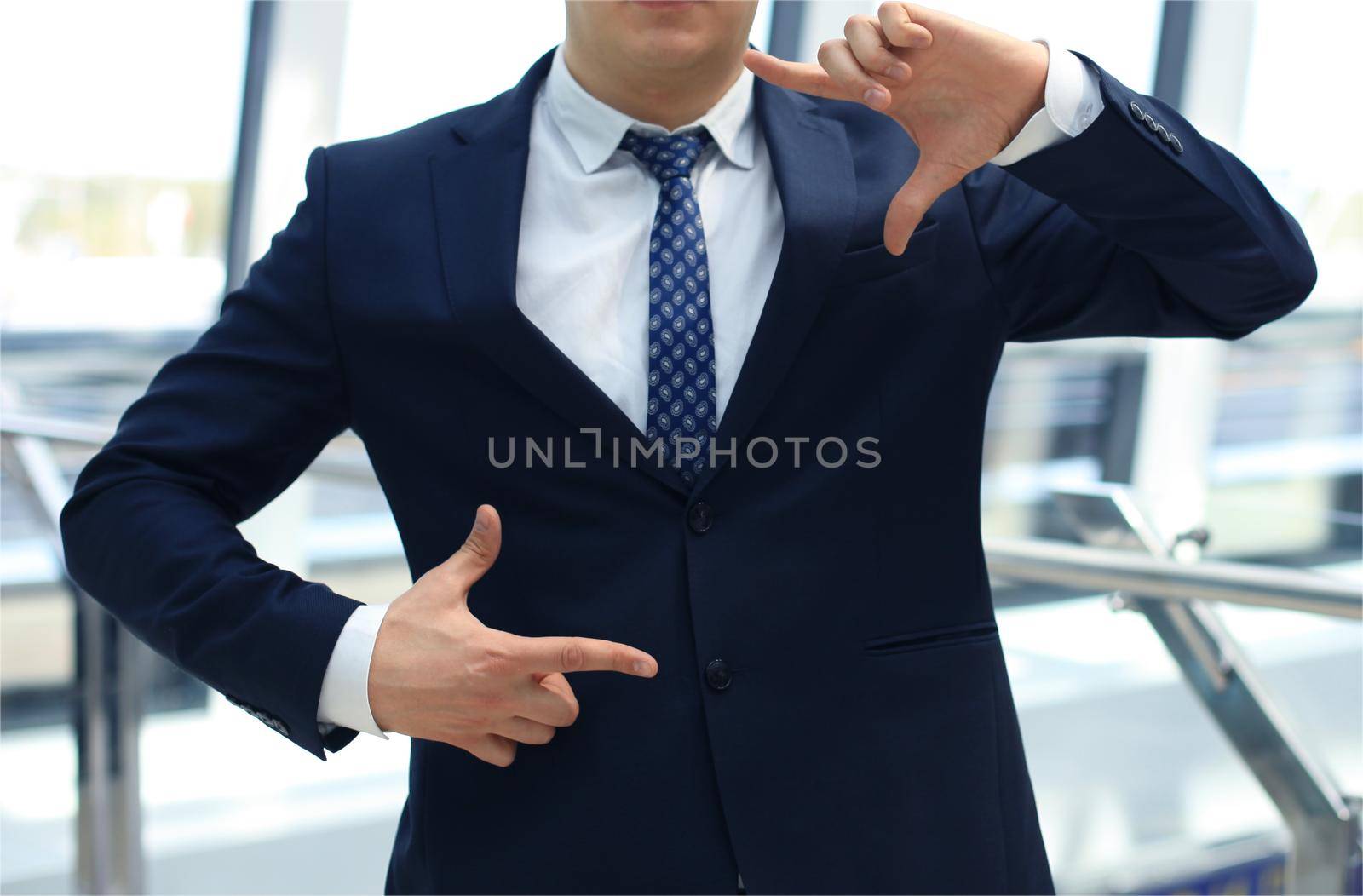 businessman showing hand square by tsyhun