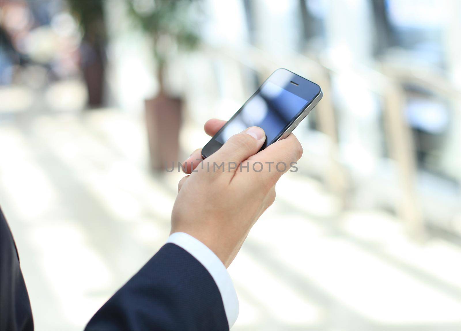 Close up of a man using mobile smart phone by tsyhun