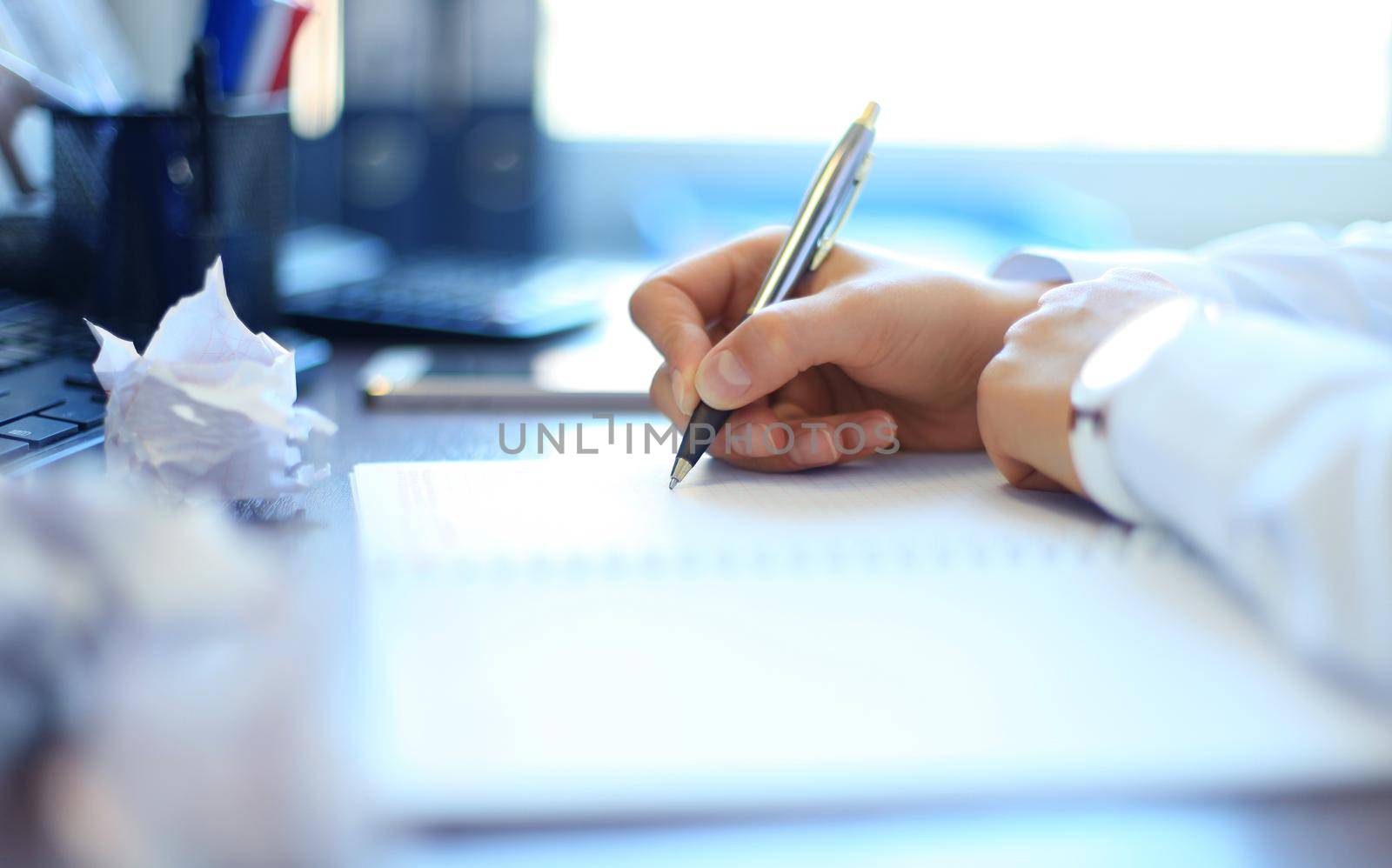 Close-up of Businesswoman makes a note at business document by tsyhun