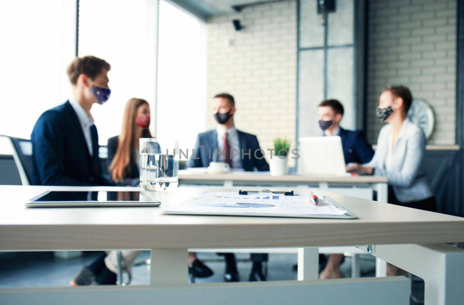 Business team in protective masks works in the office