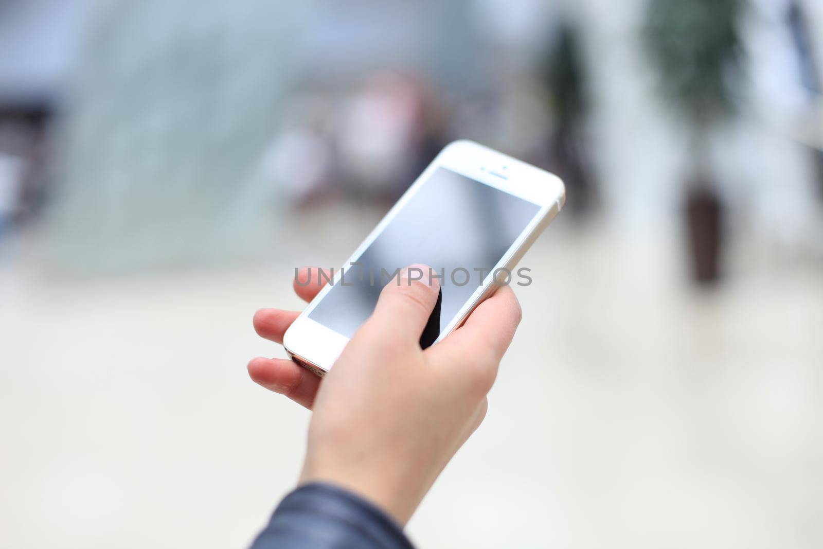 Close up of a woman using mobile smart phone by tsyhun