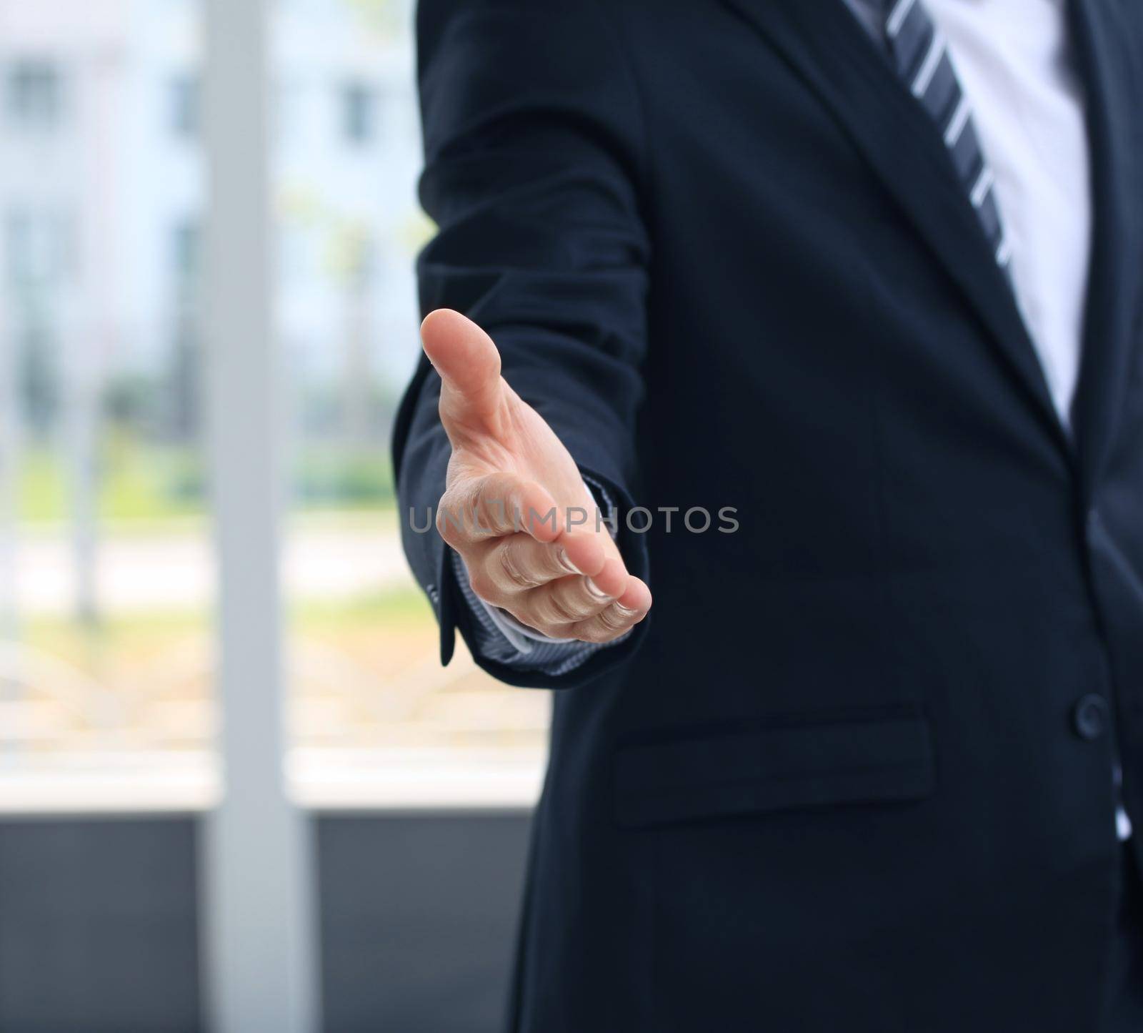 A business man with an open hand ready to seal a deal by tsyhun