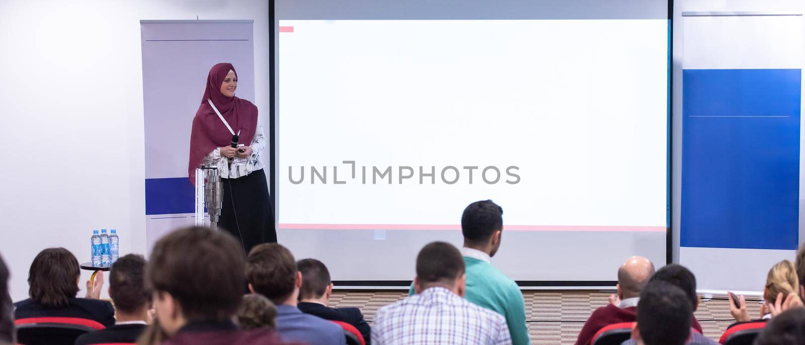 Muslim businesswoman giving presentations at conference room by dotshock