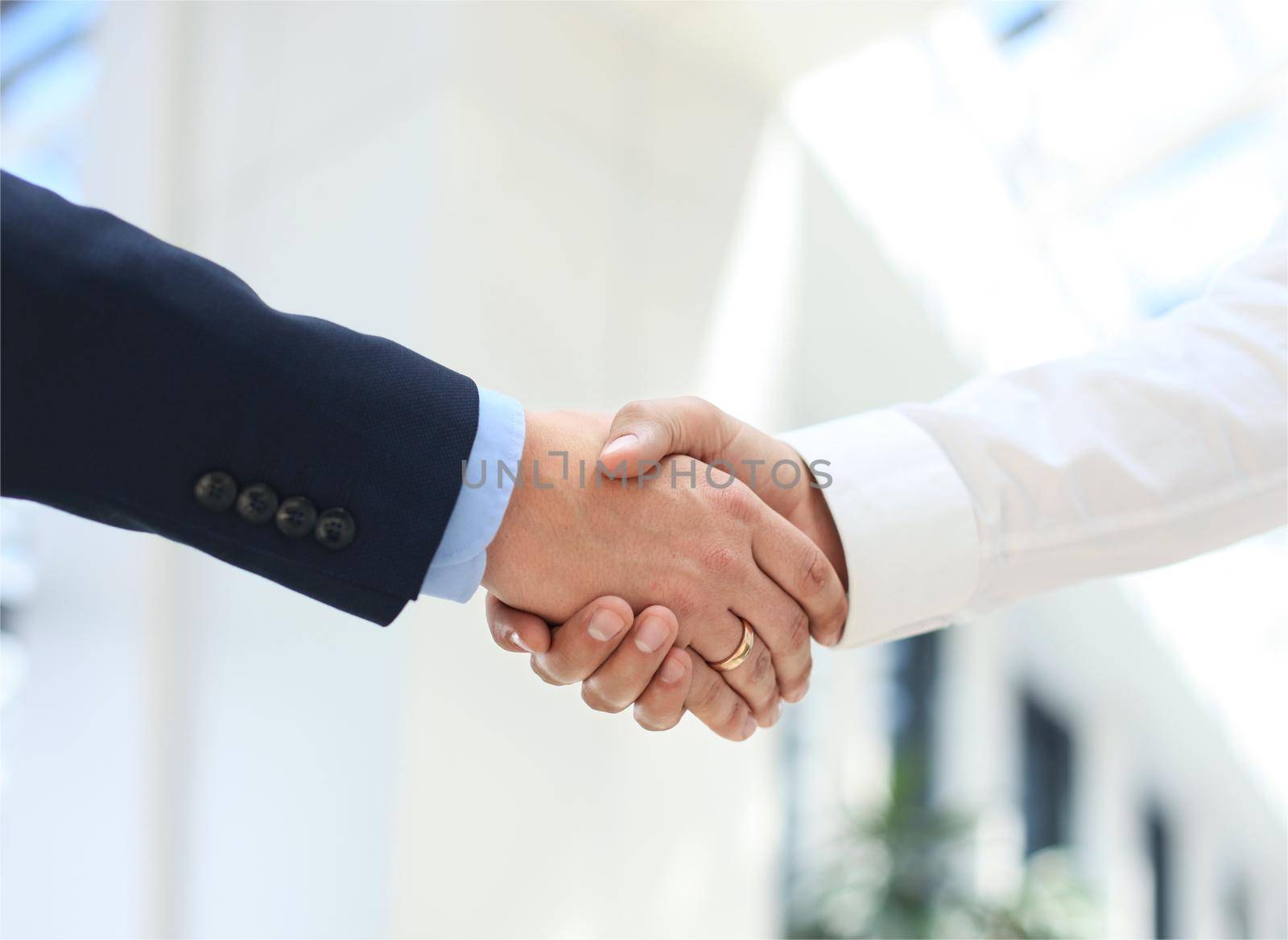 Closeup of a business hand shake between two colleagues by tsyhun