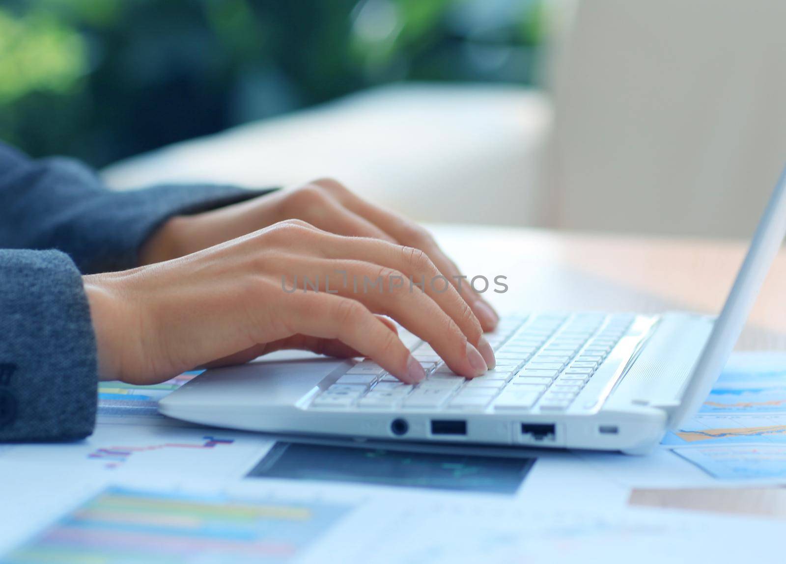 Human hands working on laptop on office background by tsyhun