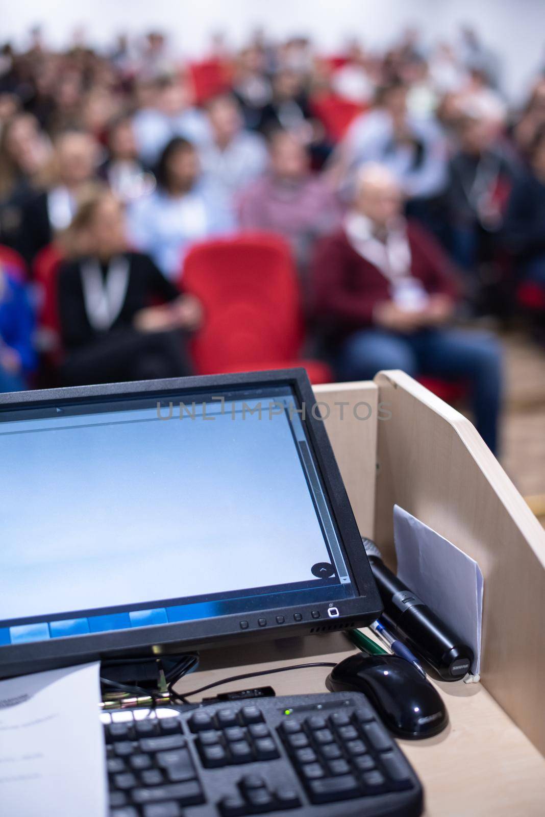 laptop computer at podium on business seminar education  in modern conference room