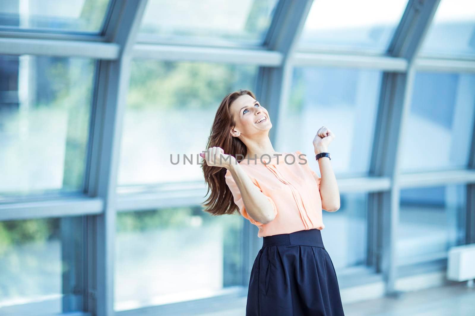 enthusiastic business woman rejoices achievements in business. the photo has a empty space for your text