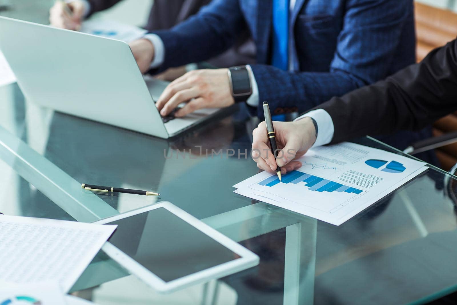 closeup of business team discussing a new financial plan of the company in the workplace in the office