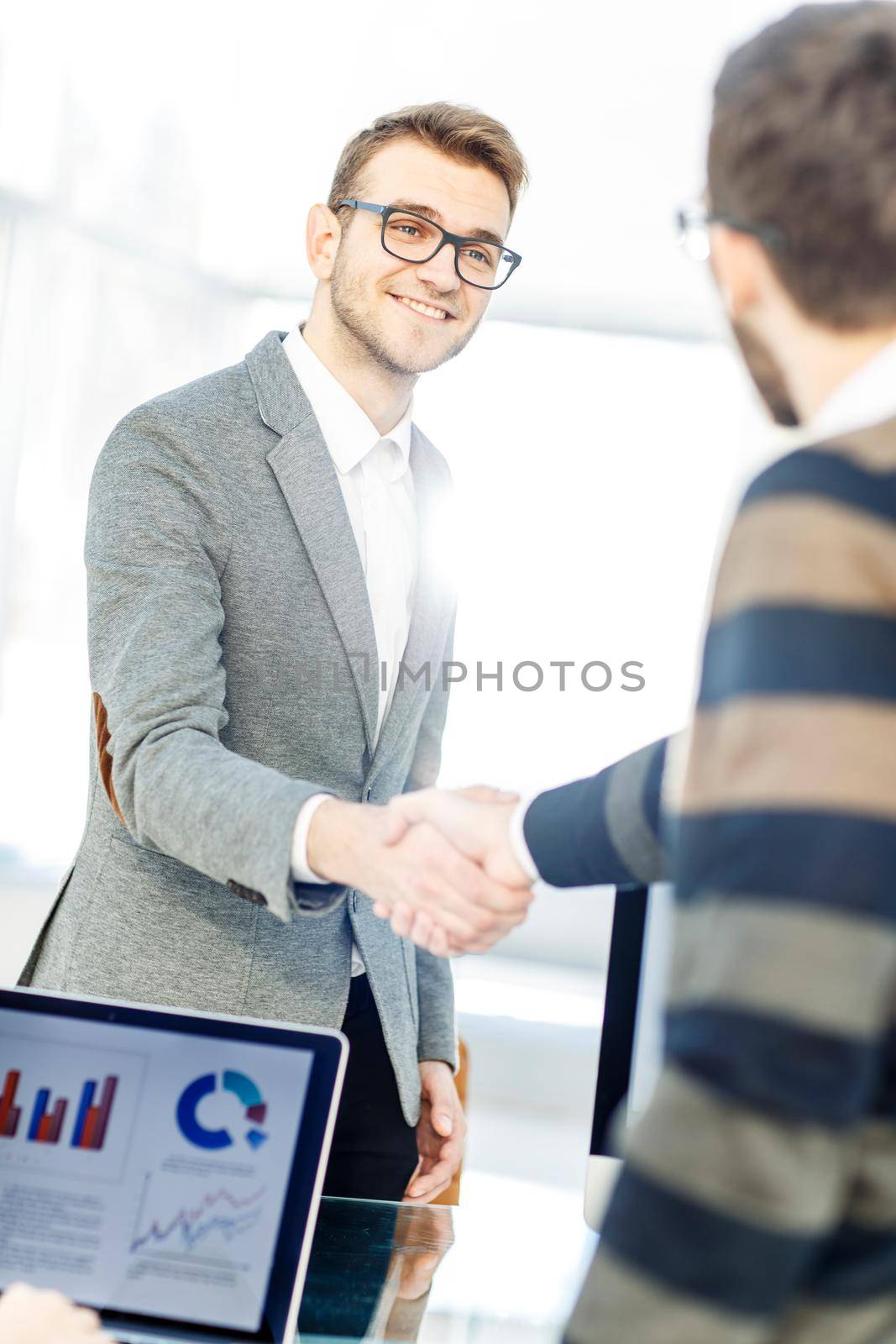 closeup - the lawyer and the client, shake hands after signing the financing contract.