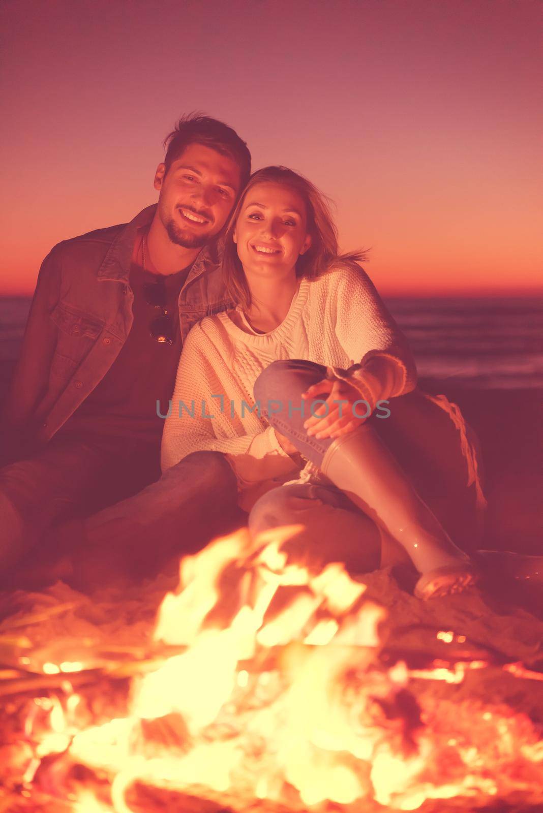 portrait of young Couple enjoying  at night on the beach by dotshock