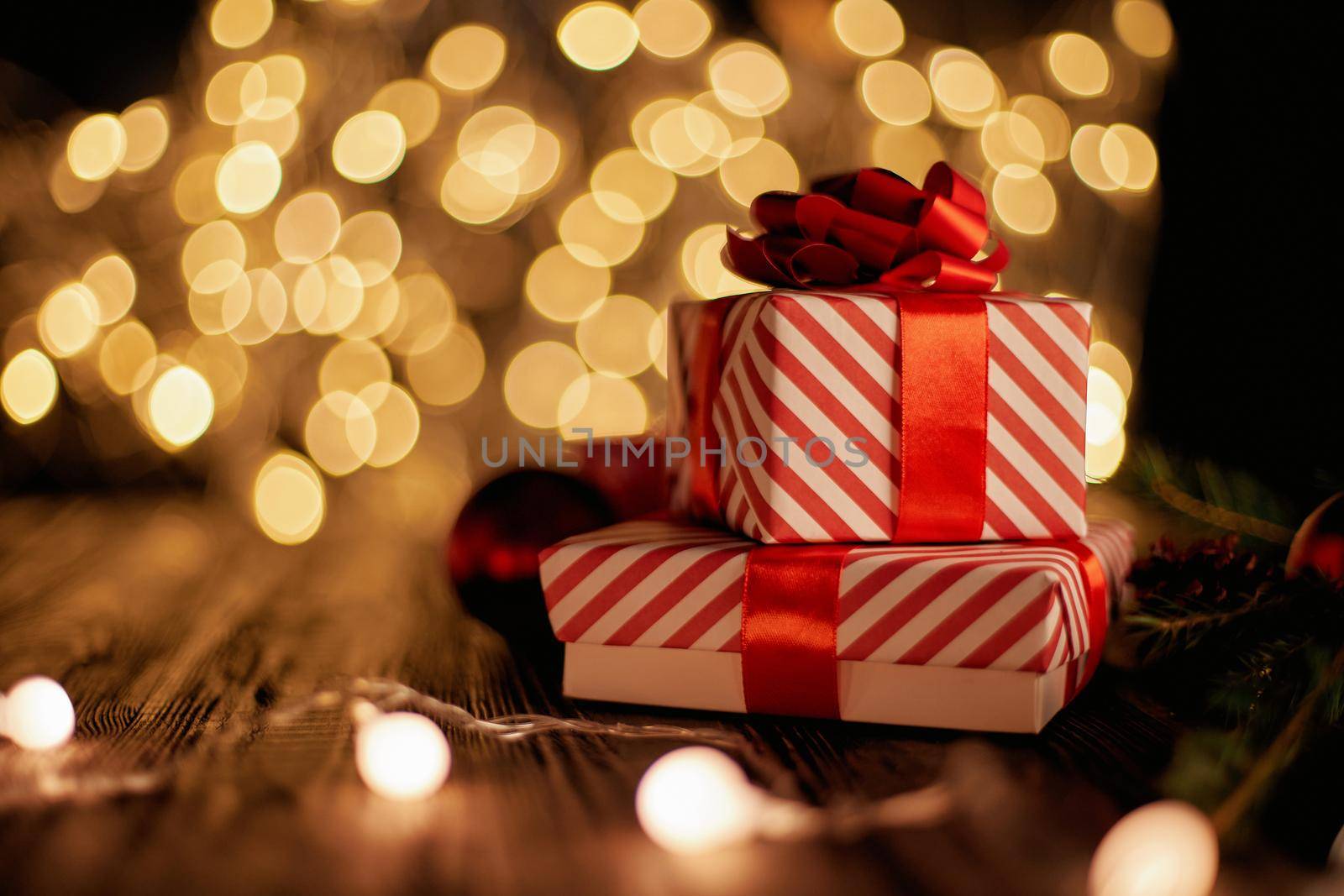 boxes with gifts and a Christmas garland on a festive background . photo with a copy-space.